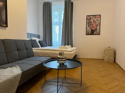 a living room with a couch and a table at Millenium Apartments in Kraków
