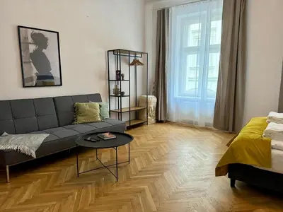 a living room with a couch and a table at Millenium Apartments in Kraków