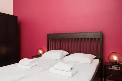 a bedroom with a bed with two towels on it at Stylowy apartament - 6 sypialni - Kraków, Stare Miasto - by Upstairs in Kraków