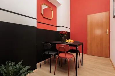 a dining room with a table and four chairs at Stylowy apartament - 6 sypialni - Kraków, Stare Miasto - by Upstairs in Kraków