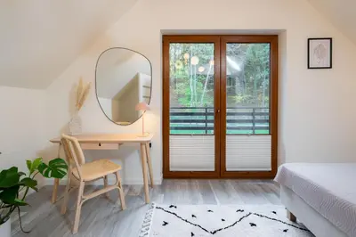 a bedroom with a desk and a mirror and a bed at Domki Kamieniec in Marcyporęba