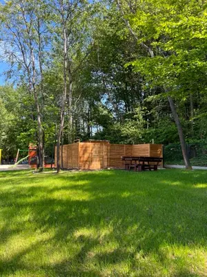a picnic table in a field of green grass at Domki Kamieniec in Marcyporęba