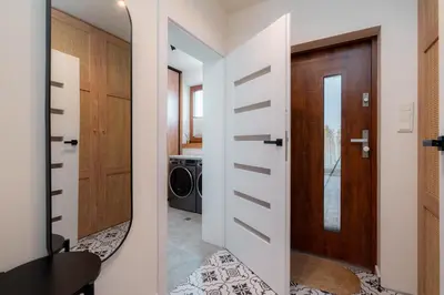 a hallway with a door leading to a laundry room at Domki Kamieniec in Marcyporęba