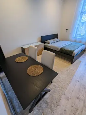 a living room with two tables and a bed at Apartment A3 in downtown of Krakow in Kraków