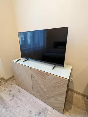 a large flat screen tv sitting on top of a cabinet at Apartment A3 in downtown of Krakow in Kraków