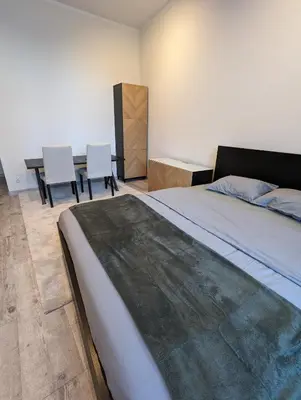 a bedroom with a bed and a table and chairs at Apartment A3 in downtown of Krakow in Kraków