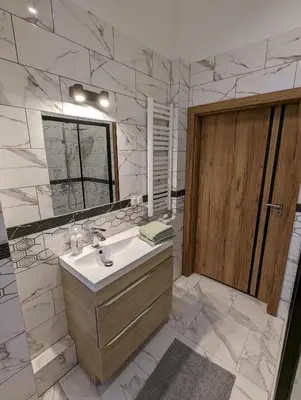 a bathroom with a sink and a mirror at Apartment A3 in downtown of Krakow in Kraków