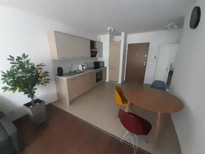a kitchen with a table and chairs in a room at Apollo Apartments Zabłocie 21 in Kraków
