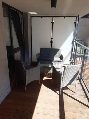 a balcony with chairs and a table on a building at Apollo Apartments Zabłocie 21 in Kraków