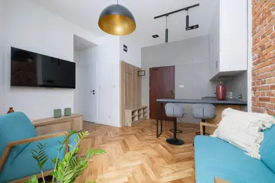 a living room with a blue couch and a table at Apartment with Private Sauna - Dietla 21 street in Kraków