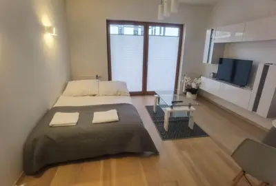 a bedroom with a large bed and a television at Novum apartment in the city center in Kraków