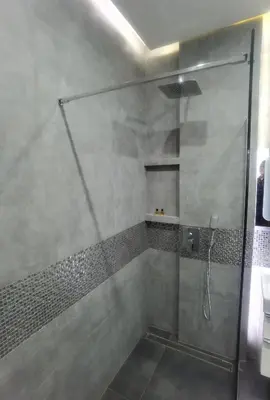 a shower with a glass door in a bathroom at Novum apartment in the city center in Kraków