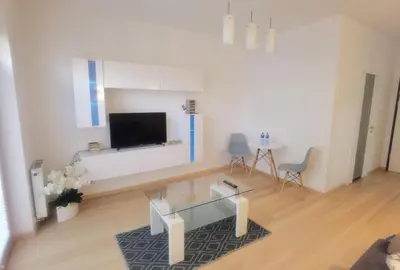 a living room with a glass table and a tv at Novum apartment in the city center in Kraków