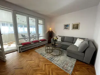 a living room with a couch and a table at Cracow Heart Apartment in Kraków