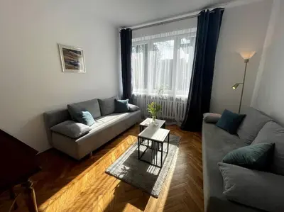 a living room with a couch and a table at Cracow Heart Apartment in Kraków