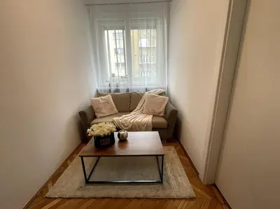 a living room with a couch and a coffee table at Cracow Heart Apartment in Kraków