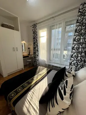 a living room with a couch and a window at Cracow Heart Apartment in Kraków