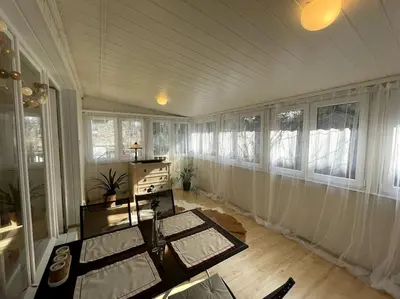 a living room with a table and some windows at Cracow Heart Apartment in Kraków