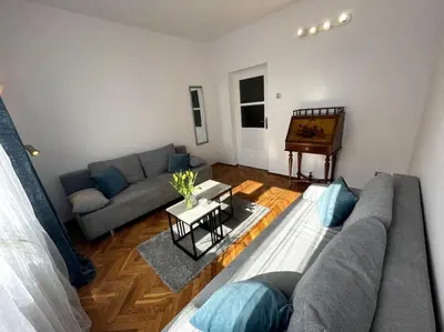 a living room with a couch and a piano at Cracow Heart Apartment in Kraków