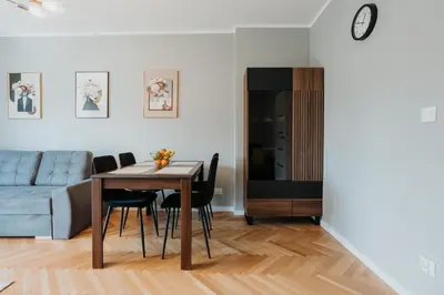 a living room with a table and a couch at Connecta Apartament in City Center with AC in Kraków