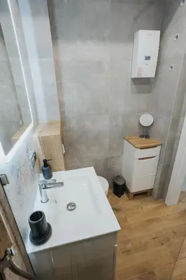 a bathroom with a sink and a toilet at Connecta Apartament in City Center with AC in Kraków