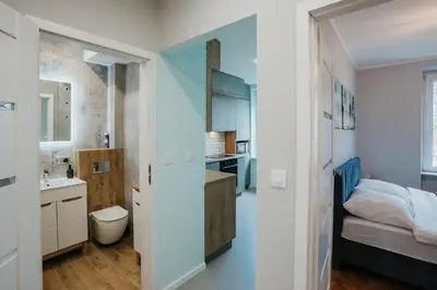a small bathroom with a toilet and a sink at Connecta Apartament in City Center with AC in Kraków