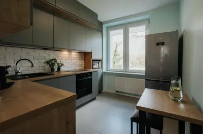 a kitchen with a stainless steel refrigerator and a window at Connecta Apartament in City Center with AC in Kraków