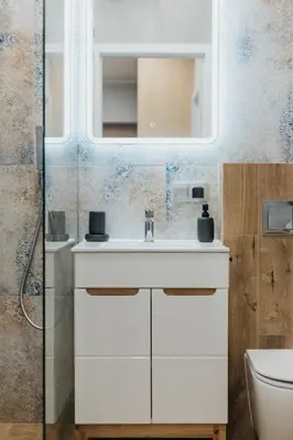 a bathroom with a sink and a mirror at Connecta Apartament in City Center with AC in Kraków