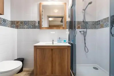 a bathroom with a sink and a shower at Bronowice Standard Studio by BookingHost in Kraków