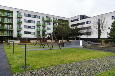 a playground in front of a apartment building at Bronowice Standard Studio by BookingHost in Kraków
