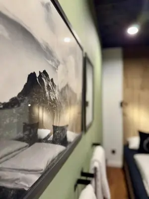 a room with a picture of a mountain on the wall at Bacówki Resort in Ochotnica Górna
