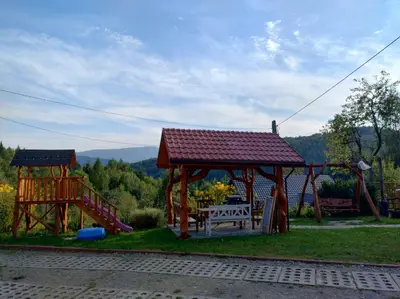 a gazebo with a bench and a playground at Dom na Smyrakach in Zawoja