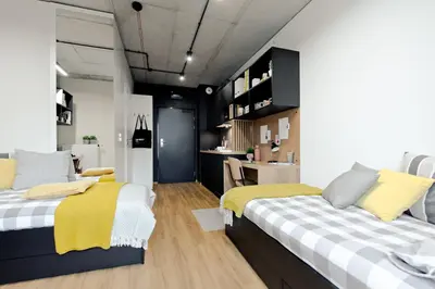 two beds in a room with black and white at SHED Living Kraków in Kraków