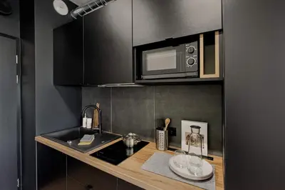 a kitchen with a counter top with a microwave at SHED Living Kraków in Kraków