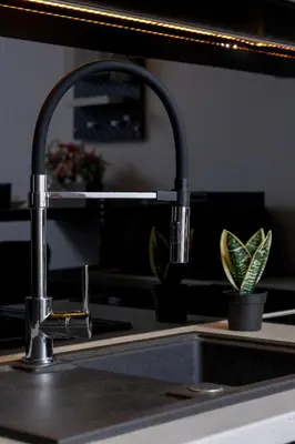 a kitchen sink with a faucet and a plant at Cosy Ariańska Apartment for 2 in Cracow Center by Noclegi Renters in Kraków