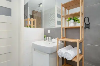a bathroom with a sink and a mirror at Cosy Ariańska Apartment for 2 in Cracow Center by Noclegi Renters in Kraków