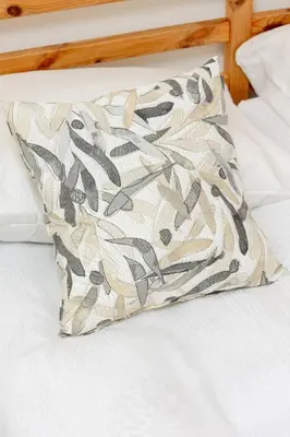 a pillow sitting on top of a bed at Cosy Ariańska Apartment for 2 in Cracow Center by Noclegi Renters in Kraków