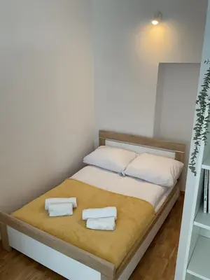 a bedroom with a bed with two towels on it at OMORIKA na Zamkowej in Kraków