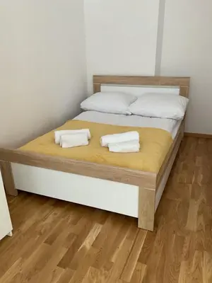 a bed with two white pillows on top of it at OMORIKA na Zamkowej in Kraków