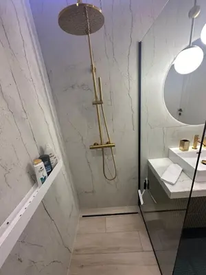 a bathroom with a shower and a sink at APARTAMENT WRAŻEŃ Kraków in Kraków