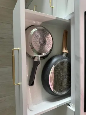 a cupboard with a kitchen utensil and a frying pan at APARTAMENT WRAŻEŃ Kraków in Kraków
