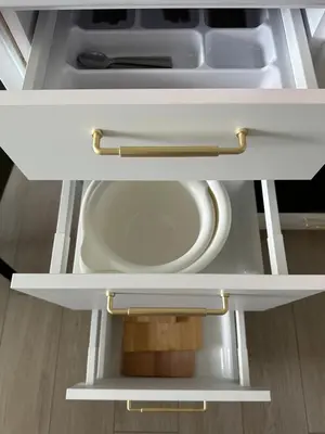 an open drawer in a white refrigerator at APARTAMENT WRAŻEŃ Kraków in Kraków