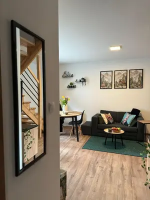 a living room with a couch and a table at Na Kamieńcu domki in Rzyki