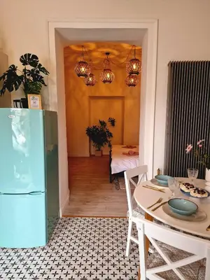 a kitchen with a table and a blue refrigerator at Apartament Kety Rynek Mickiewicza in Kęty