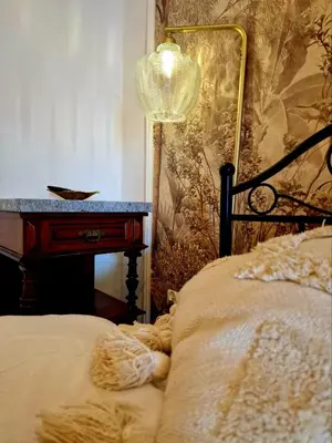 a bedroom with a bed with a lamp and a desk at Apartament Kety Rynek Mickiewicza in Kęty