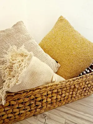 a basket filled with pillows on a wooden floor at Apartament Kety Rynek Mickiewicza in Kęty