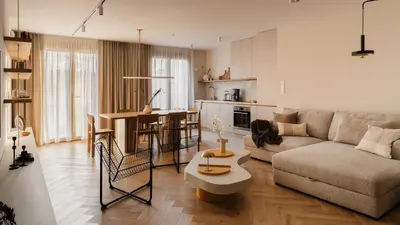 a living room with a couch and a table at Kossak Residence, Sun & Snow in Kraków