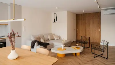 a living room with a couch and a table at Kossak Residence, Sun & Snow in Kraków