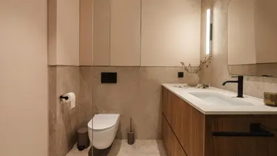 a bathroom with a toilet and a sink at Kossak Residence, Sun & Snow in Kraków
