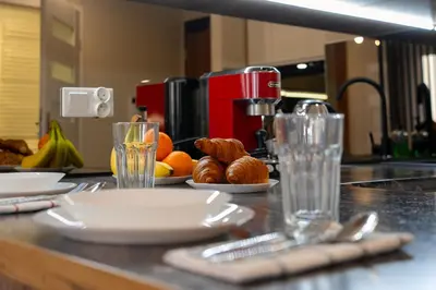 a kitchen counter with plates and utensils and fruit at Ekskluzywny apartament + garaż in Kraków